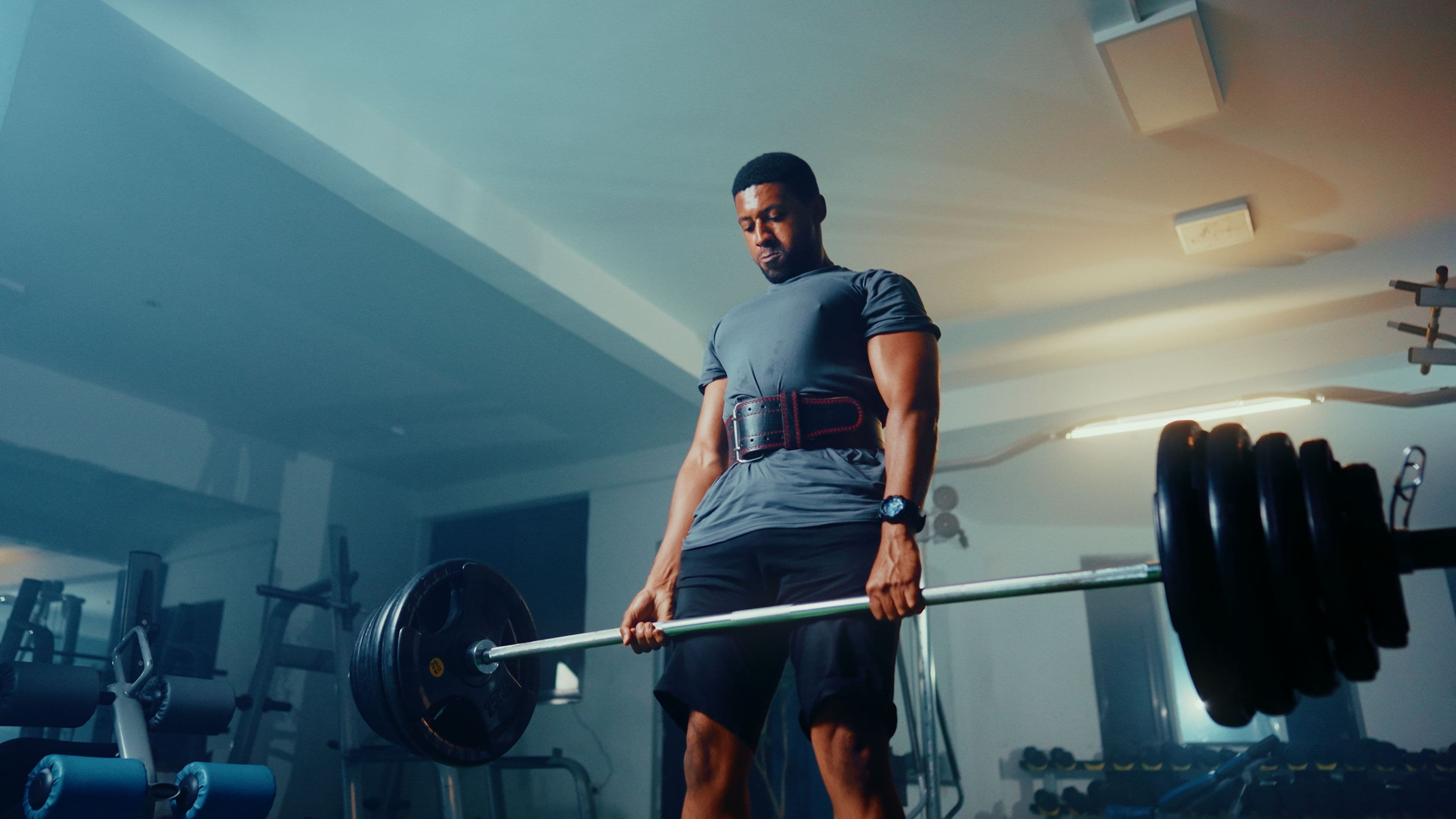 A man mid-lift, training with focus and discipline