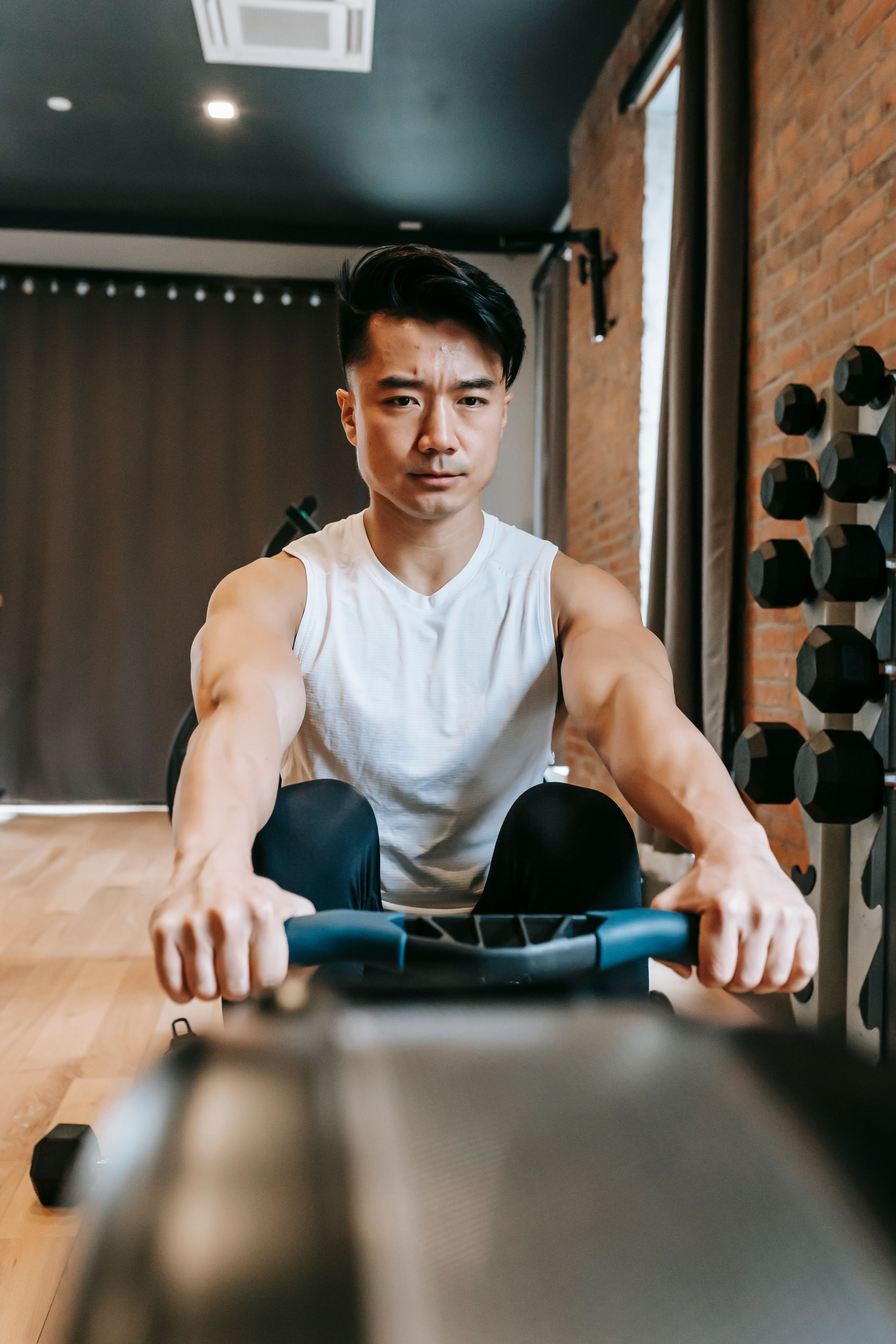 A man mid-set on a rowing machine